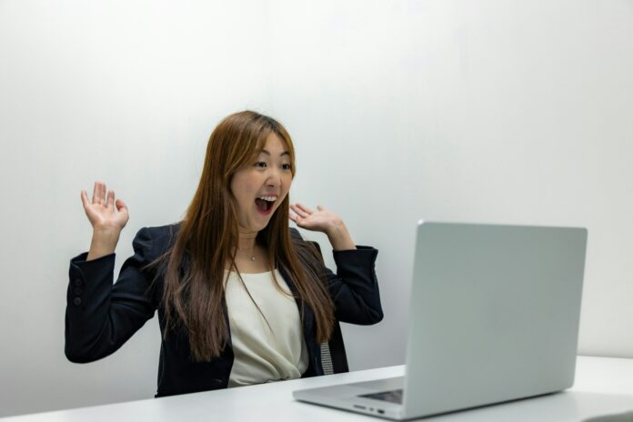 a-woman-sitting-in-front-of-a-laptop-computer